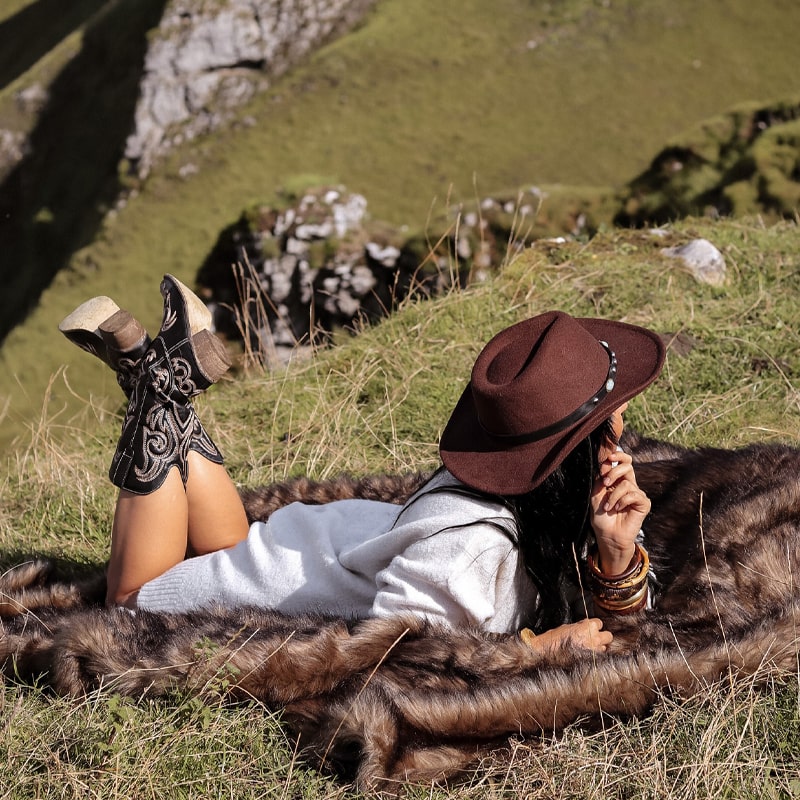 A brown aztec faux fur blankets sprawled on the floor.