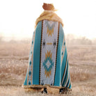 A person covered in a classic Aztec Faux Fur Throw Blanket in the sun.