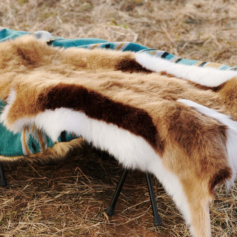 A Faux Impala Pelt Rug and an Aztec Faux Fur Blanket.