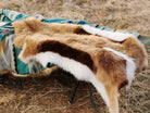 A Faux Impala Pelt Rug and an Aztec Faux Fur Blanket.