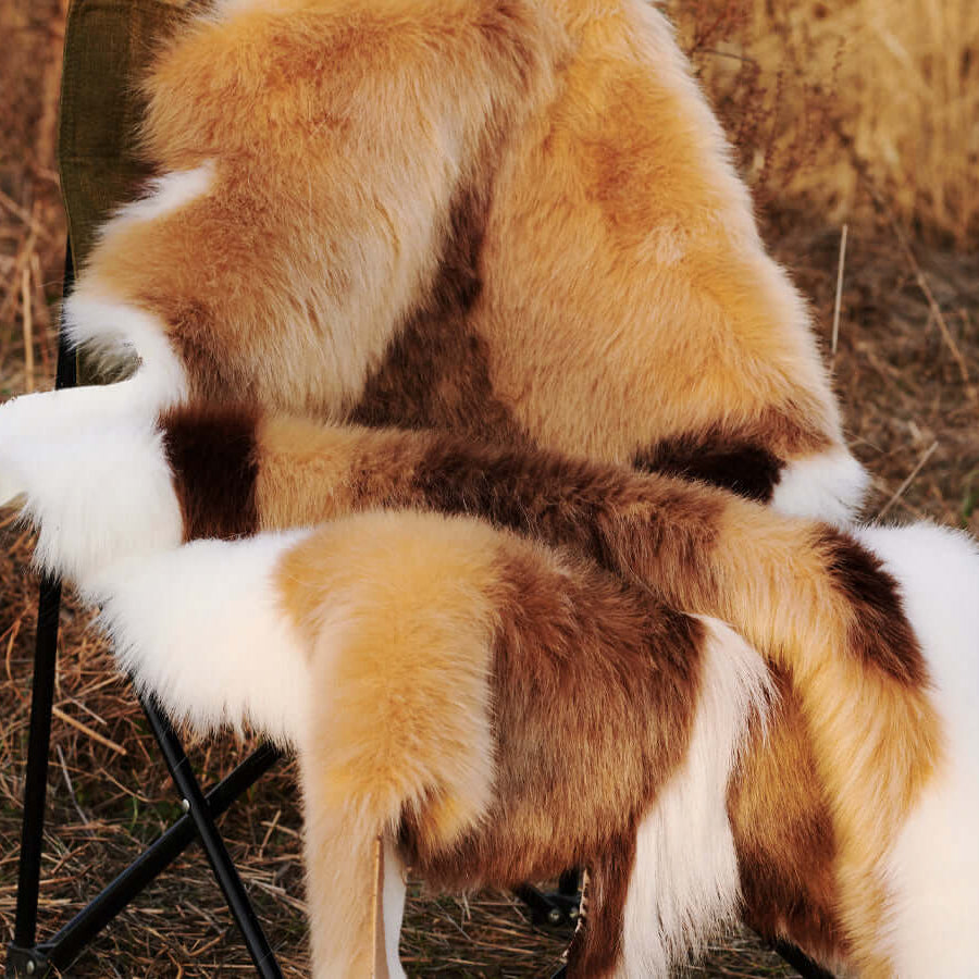 A chair covered by a high-end Faux Impala Pelt Rug.