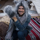 A model wearing a faux fur hood, which is cute and suitable for cosplay. It contains a warm hood, a scarf, and gloves.