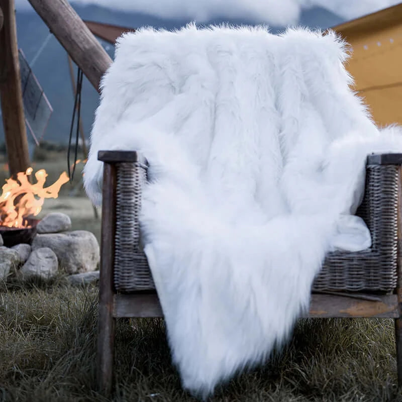 A queen size white faux fur throw blanket on the sofa. Can also be used as faux fur duvet cover. Easy to clean and keep warm