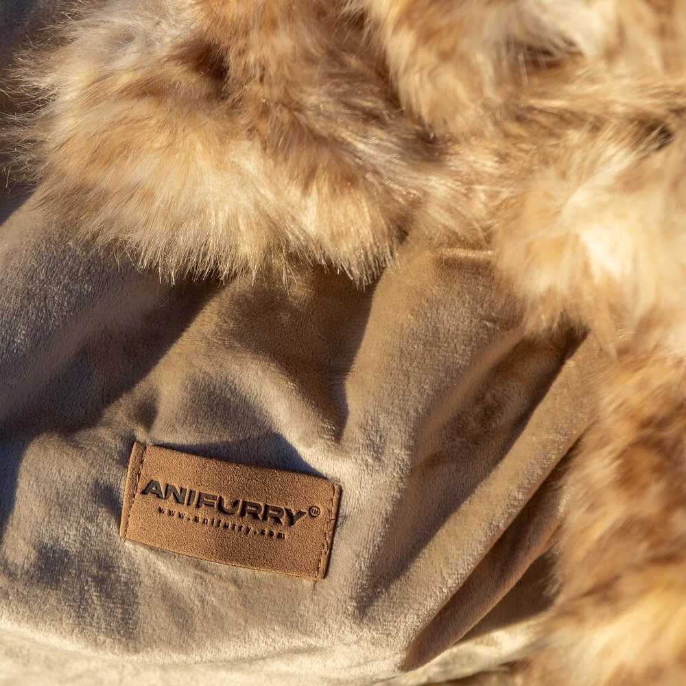 A reversible blanket with one side made of soft leopard faux fur and the other side in plush velvet with Anifurry trademark label on.