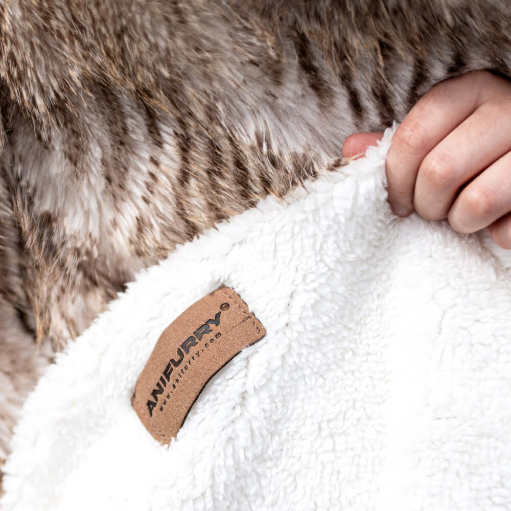 A reversible blanket with one side jacquard faux fur while the fleece with trademark label on the back.