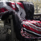 A cozy grey and red faux fur blanket with classic patterns. Suitable for keeping warm. Machine washable and easy to store.