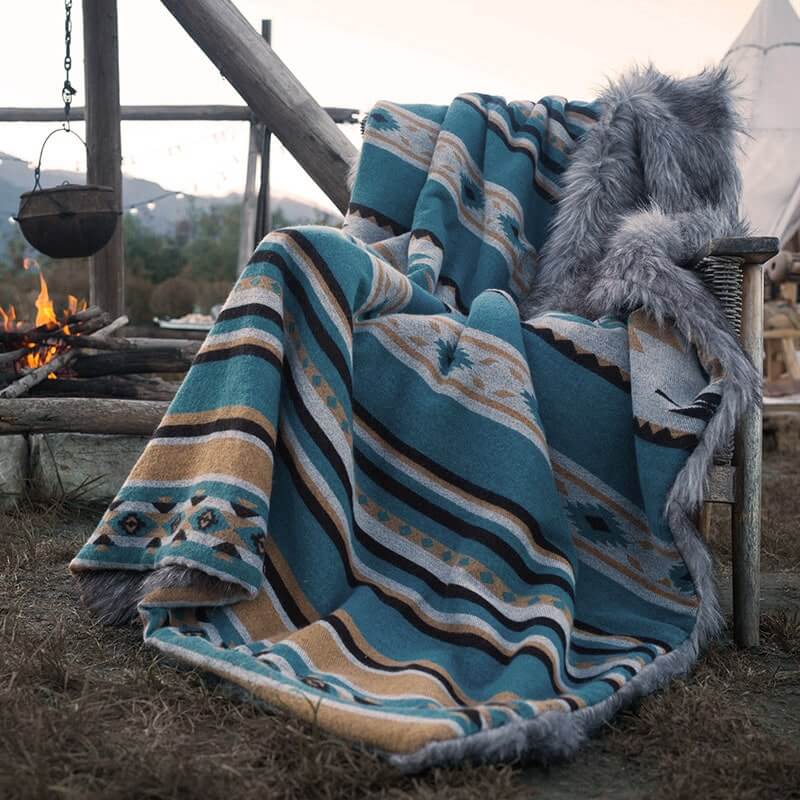 A cozy grey and teal faux fur blanket with classic patterns. Suitable for keeping warm. Machine washable and easy to store.