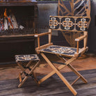Anifurry Mohave director chair and stool with patterned seats next to a fire pit on a wooden deck.