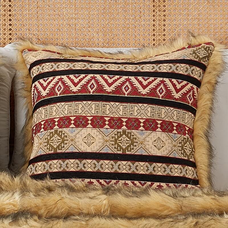  Golden faux fur & Ruby Kilim style pillow cover on a bed with a same color faux fur blanket.