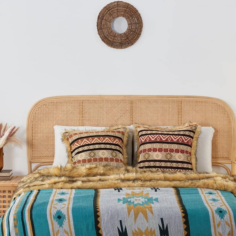 Ocher Kilim Faux Fur Pillow Cover and Turquoise aztec grey faux fur blanket on the bed.