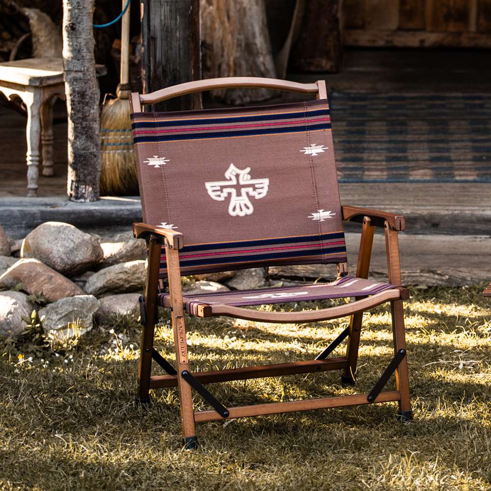 Anifurry wood camping chair with a thunderbird-patterned fabric in an outdoor setting.
