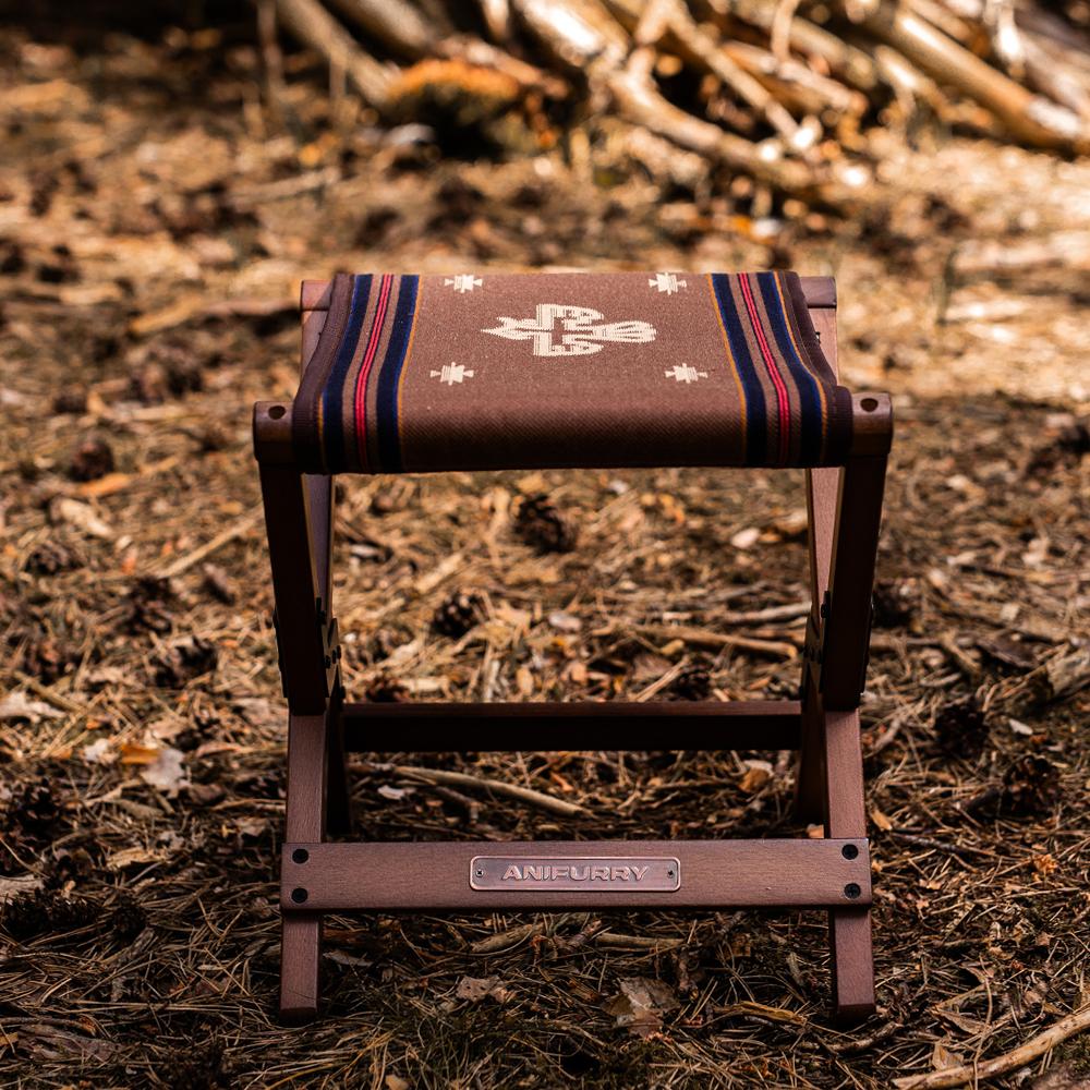 Anifurry wood outdoor stool with striped cushion in a forest setting