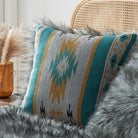 The Turquoise aztec pattern on one side and luxurious faux fur on the other pillow covers on the bed.