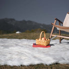 The glossy white rug with luxurious faux fur is on the grass. It has one fluffy side and one non-slip reverse side.