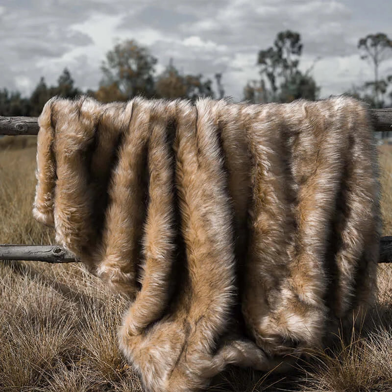 A queen size golden faux fur blanket with soft and fluffy material. Suitable for keeping warm and decorating rooms.